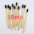 Ten bamboo toothbrushes with black charcoal bristles, laid out in a fan